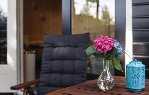 a vase of flowers sitting on a table with a candle at Pet Friendly Home In Bruchterveld in Bruchterveld