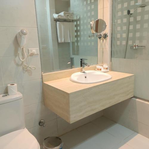 a bathroom with a sink and a toilet at Gloria Aqua Park Hotel in Aswan