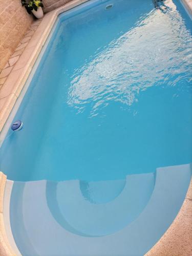 a swimming pool with blue water in it at La Madriguera de Toledo in Bargas