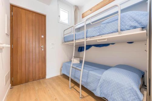 a bedroom with two bunk beds and a door at Garda Paola Lake Experience 2 in Manerba del Garda