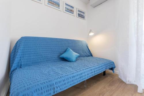 a blue bed with a blue pillow on top of it at Garda Paola Lake Experience 2 in Manerba del Garda
