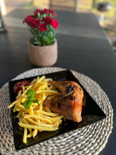 a plate of food with pasta and meat on a table at Caravana Juliana - Glamping in Swaderki