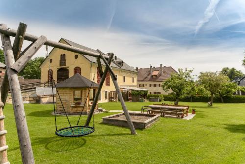 a playground with a swing in a yard at Haus König in Mauterndorf