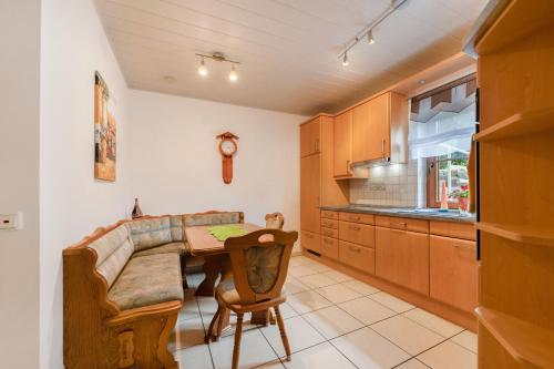 a kitchen with a couch and a table in a room at Fewo Lora in Blankenrath