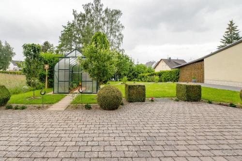 a greenhouse in the middle of a garden at Fewo Lora in Blankenrath