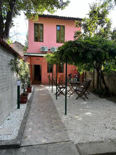 a pink house with a patio in front of it at Il Glicine in Parma