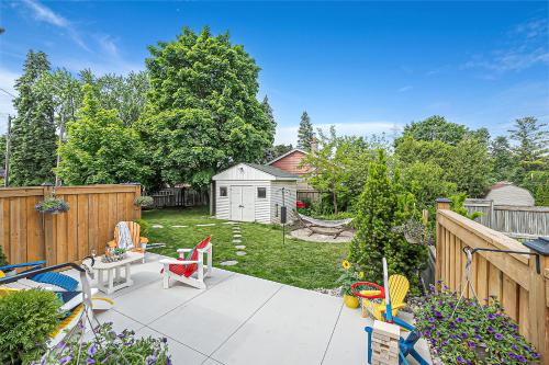 a backyard with a patio with chairs and a fence at Luxury Family Home in Burlington in Burlington