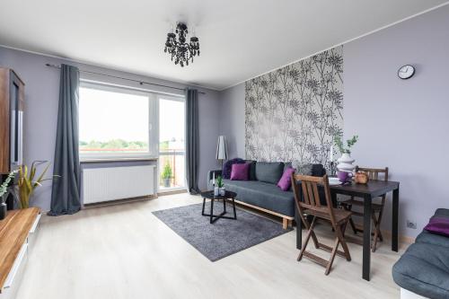 a living room with a couch and a table at SuperApart Pożarowa 3B, parking in Warsaw