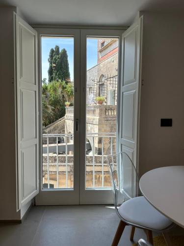 a room with a window with a view of the city at Design, comfort e atmosfera nel cuore del Salento in Martano