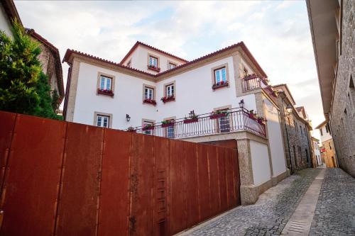 a white house with a red fence at Mponto in Ponte da Barca