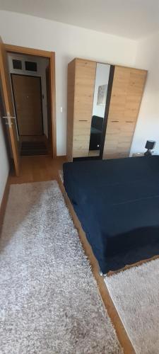 a room with a bed and a door and a rug at Elegance in Zemun