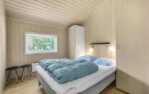 a bedroom with a bed in a small room at Amazing Home In Rødby With Sauna in Rødby