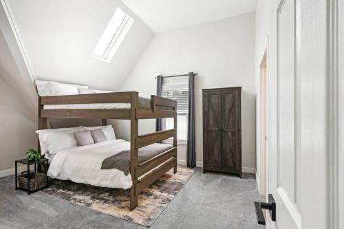 a bedroom with a bunk bed in a attic at Historic Home in Brewers Hill with hot tub! in Milwaukee