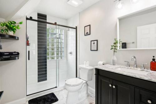 a bathroom with a shower and a toilet and a sink at Historic Home in Brewers Hill with hot tub! in Milwaukee