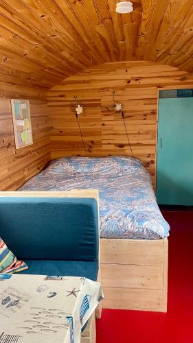 a bedroom with a bed in a wooden room at Island Sleeping in Aalsmeer