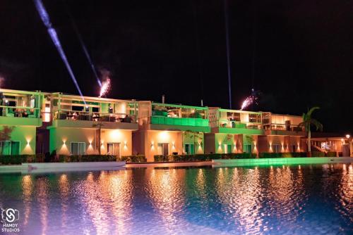 a building with a pool in front of it at night at Marom Port Said Resort & Beach in Port Said