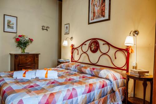 a bedroom with a bed with a colorful blanket at Antica Casa Dei Rassicurati in Montecarlo