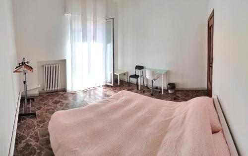 a bedroom with a bed and a table in a room at White house in Bari
