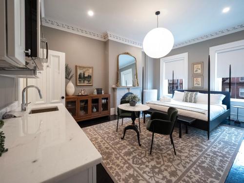 a bedroom with a bed and a table and chairs at The Chester Hotel in Boston