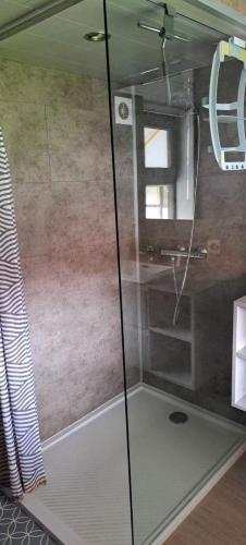 a shower with a glass door in a bathroom at Duinengolf 37 in Middelkerke
