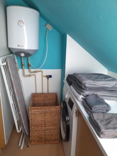 a laundry room with a washing machine and a blue ceiling at Holiday apartment & boat rental in Sindal