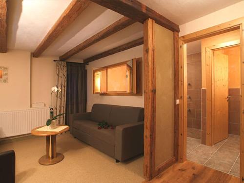 a living room with a couch and a table at Hotel Riederhof- Urlaub mit WAU! in Ried im Oberinntal