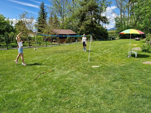 two people playing with a kite in a field at Žiar Apartmány 43 in Žiar