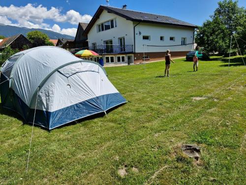 a group of people standing in a field with a tent at Žiar Apartmány 43 in Žiar