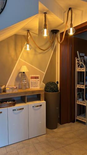 a kitchen with two lights and a table and a trash can at Civico 13 in Scardovari