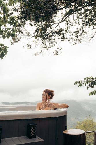 a woman in a bath tub with a view at Amalú Luxury View Cabins in Monteverde Costa Rica