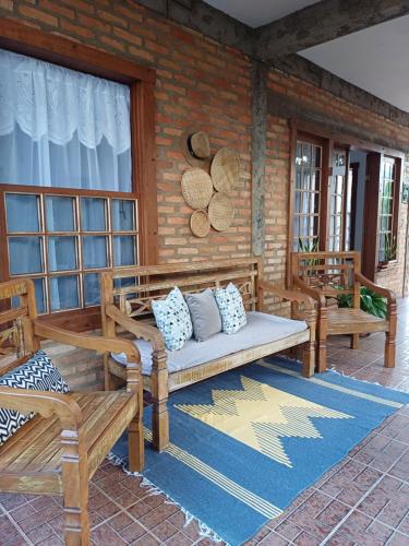 a porch with a couch and benches on a patio at Pousada Despertar de Minas in Tiradentes