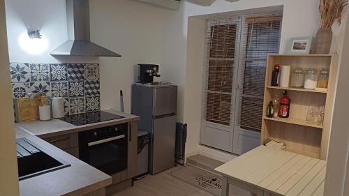une cuisine avec une cuisinière et un réfrigérateur dans l'établissement Appartement a 50m du port du pouliguen linges non inclus, au Pouliguen