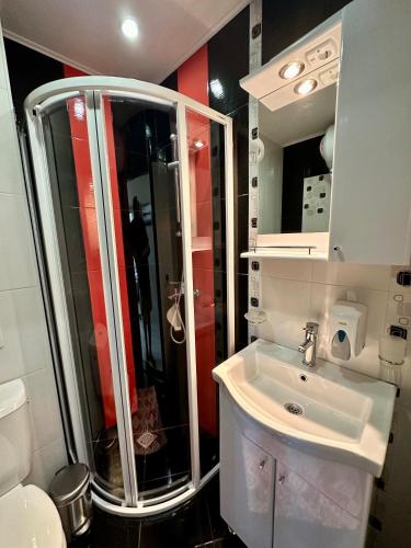 a bathroom with a shower and a white sink at Sea View Private Studio Paradiso B 508 in Nesebar