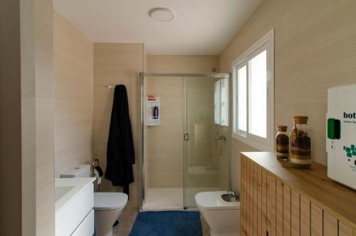 a bathroom with a shower and a toilet and a sink at El Atico de Andrea in Torre del Mar