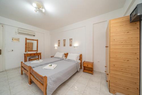 a bedroom with a bed and a television in it at Fiore Di Mare Studios in Lassi