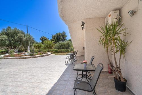a patio with chairs and a table on a patio at Fiore Di Mare Studios in Lassi
