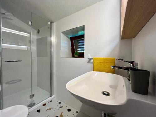 a white bathroom with a sink and a shower at Stone House Mia in Premantura