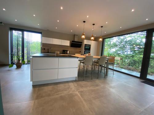 a kitchen with a island and a table with chairs at Gîte de la Tour in Hotton