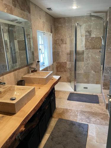 une salle de bain avec deux lavabos et une douche dans l'établissement Maison de caractère, conviviale, à Boissy-le-Cutté