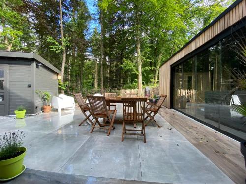 a patio with a table and chairs on it at Gîte de la Tour in Hotton