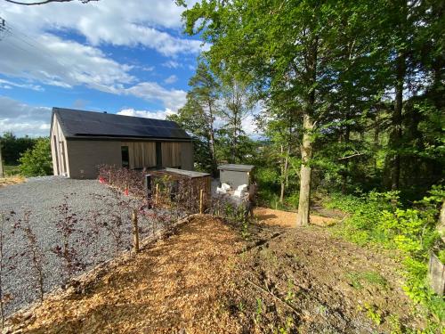 a house with a fence in front of a yard at Gîte de la Tour in Hotton