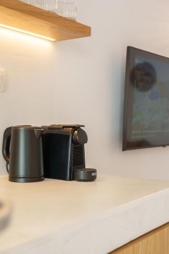 a kitchen counter with two pots on a counter top at Villa Karterados Suites in Karterados