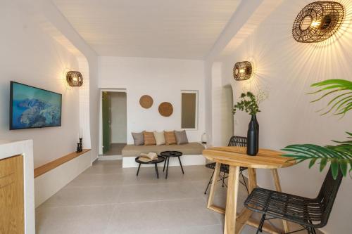 a living room with a table and a couch at Villa Karterados Suites in Karterados