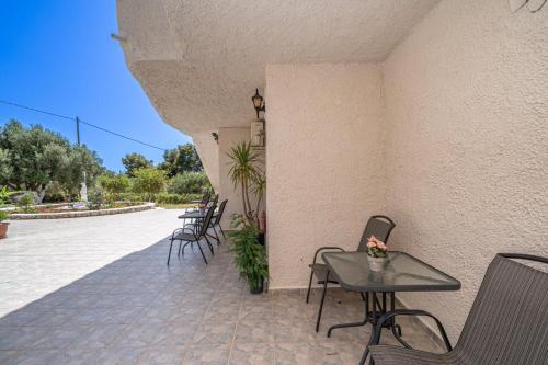 a patio with chairs and tables on a building at Fiore Di Mare Studios in Lassi