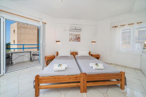 a bedroom with a bed and a balcony at Fiore Di Mare Studios in Lassi