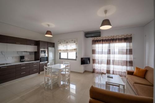 a living room with a couch and a table at Franklin Rooms in Sarandë