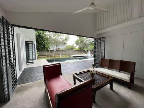 a living room with a couch and a table at KL PJ Garden Pool Villa Karaoke in Petaling Jaya