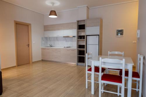a kitchen and dining room with a table and chairs at Franklin Rooms in Sarandë