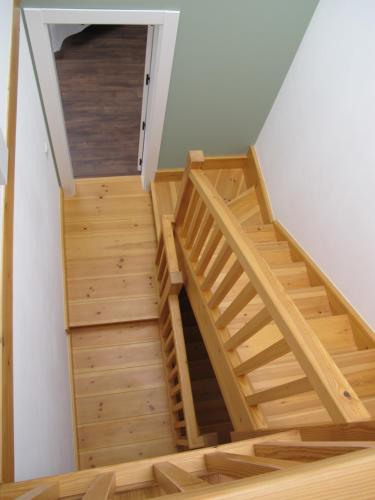 a staircase in a house with wooden flooring at Casa Vacacional La Pedrera in Baró