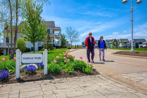 two people walking down a street in a park at Harbor Master Villa in Ottawa